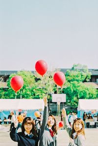 Group of people with balloons at street
