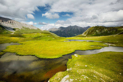 Scenic view of lake and mountains against sky