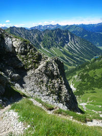 Scenic view of land and mountains against sky