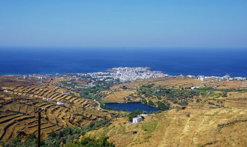 Aerial view of sea and buildings against sky