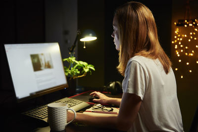 Woman using mobile phone at table