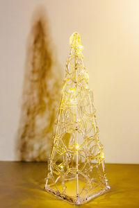 Close-up of christmas decoration on table against wall