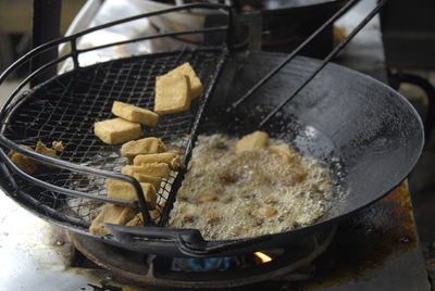 Close-up of cooking pan on barbecue grill