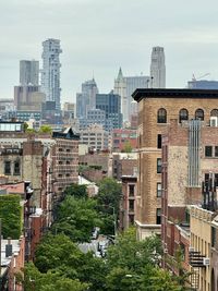 Buildings in city against clear sky