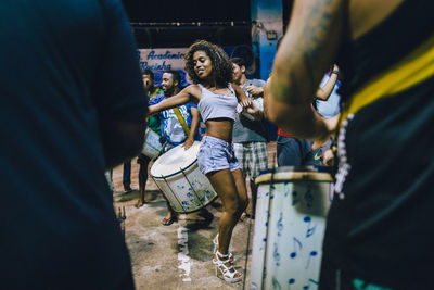 Low angle view of people playing at music concert