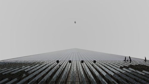 Low angle view of modern skyscraper against sky