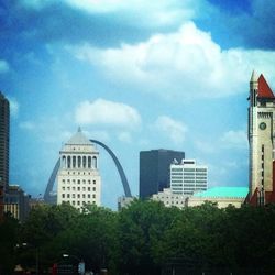 Low angle view of buildings against cloudy sky