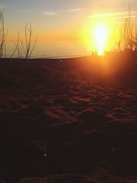 Scenic view of sea against dramatic sky during sunset