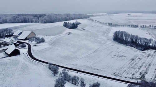 Scenic view of snow covered field against sky