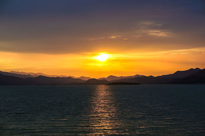 Scenic view of sea against romantic sky at sunset