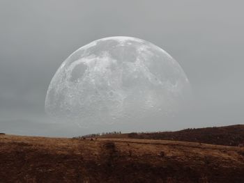 Scenic view of land against sky at night