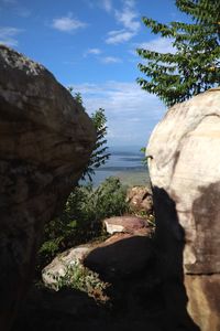 Rock formation by mountain against sky
