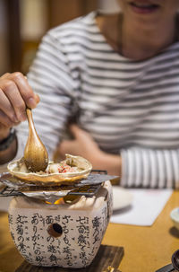 Woman eating seafood at restaurant in kyoto