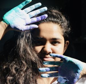 Close-up portrait of beautiful woman holding camera