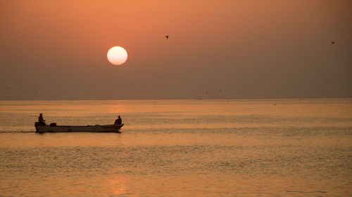 Scenic view of sea against clear sky during sunset