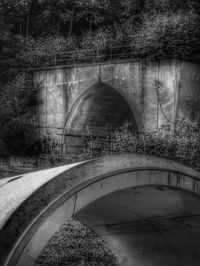 Arch bridge over river in tunnel