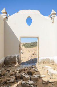 Built structure on sand against clear sky