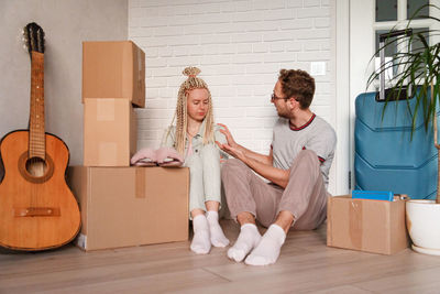 Young couple sitting on floor