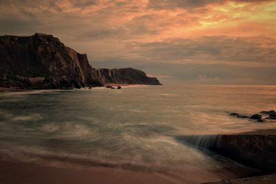 Scenic view of sea against dramatic sky