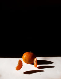 Close-up of orange slices over black background