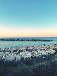 Scenic view of sea against clear sky during sunset
