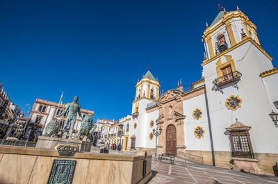 Low angle view of building against clear blue sky