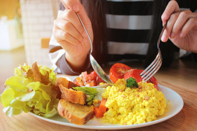 Close-up of man holding food in plate