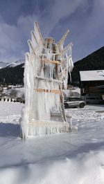 Icicles on building against sky during winter