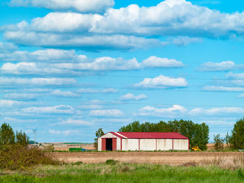 Built structure on field against sky