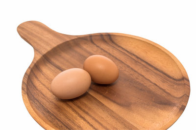 Close-up of eggs on table against white background