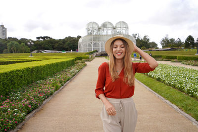 Young woman walking looking down in the botanical garden of curitiba, parana, brazil