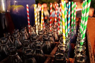 Close-up of glass bottles with drinking straws