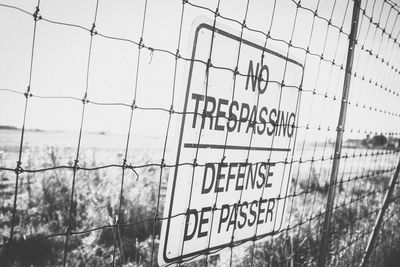 Warning sign by fence