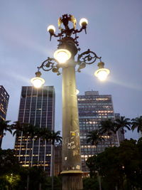 Low angle view of illuminated skyscraper against sky