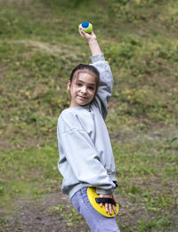 Side view of boy playing with ball on field