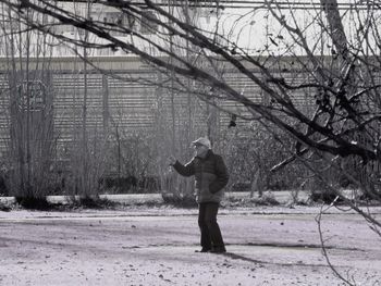 Full length of man standing on field during winter