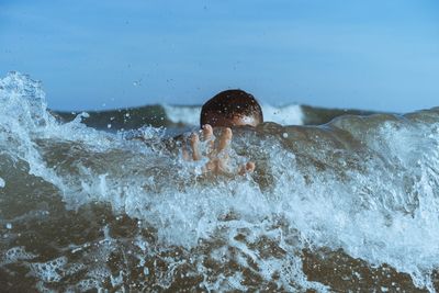 Boy swimming in sea