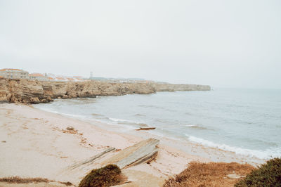 Scenic view of beach against clear sky