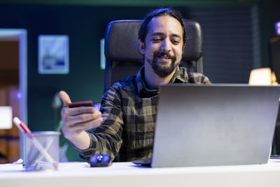 Young woman using laptop at table