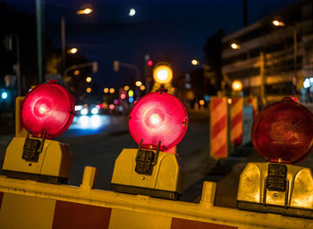 Close-up of illuminated lanterns in city at night