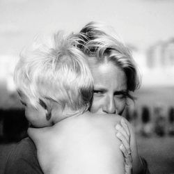 Portrait of mother with son standing outdoors