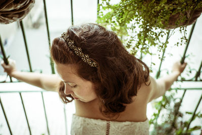 Close-up of bride standing by railing