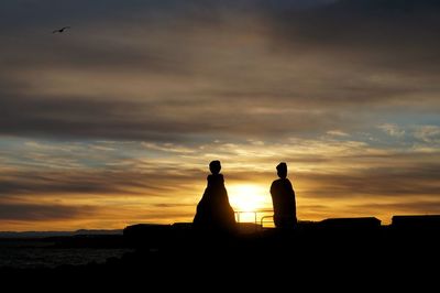 Silhouette of built structure at sunset