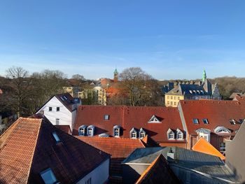 High angle view of townscape against blue sky