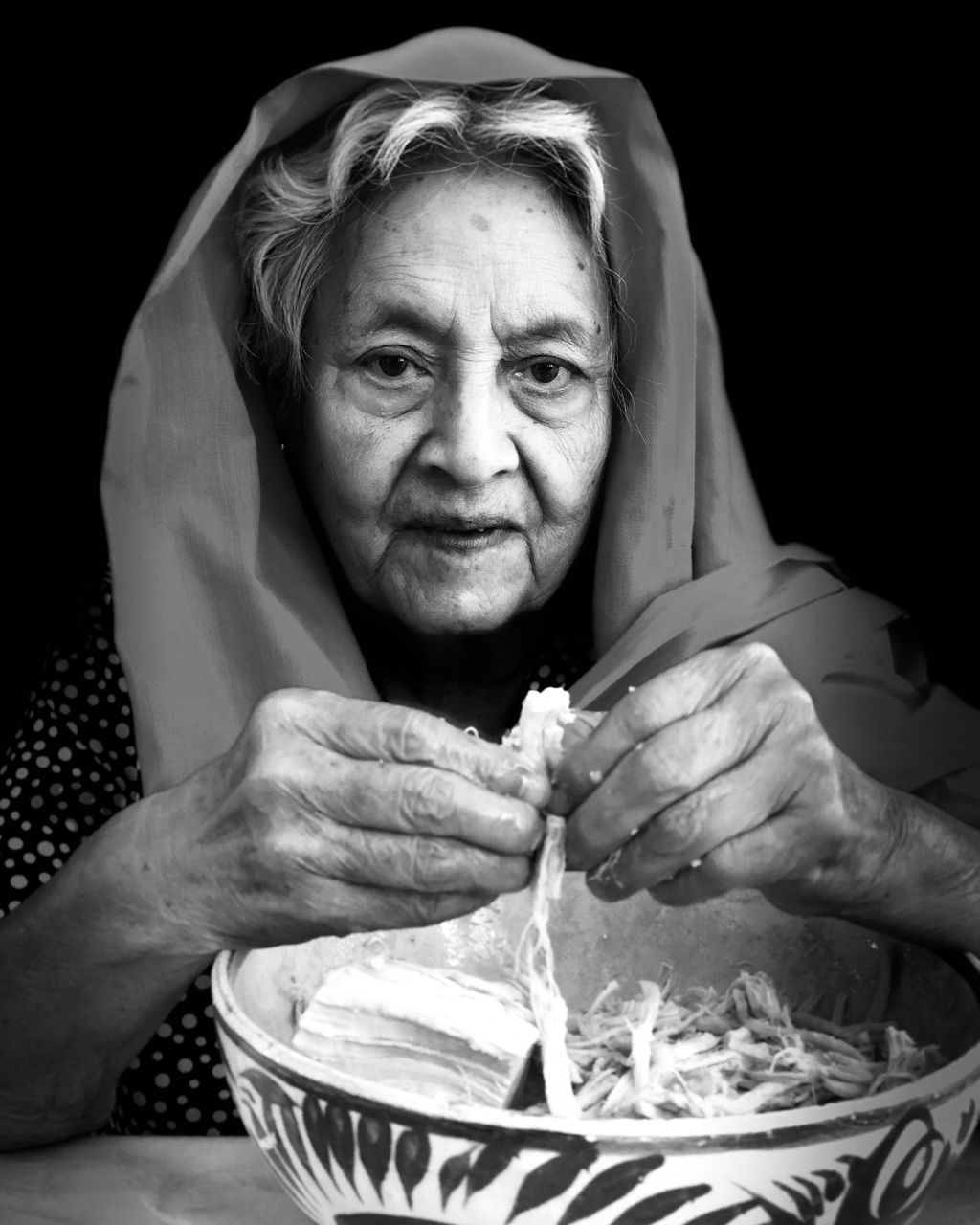 portrait, looking at camera, adult, senior adult, front view, one person, food and drink, men, males, holding, women, lifestyles, headshot, real people, food, indoors, sitting, hand, senior women, black background, mature men, hungry