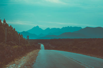 Road amidst mountains against sky