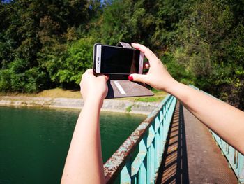 Low section of person using mobile phone