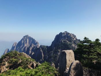 Scenic view of mountains against clear blue sky