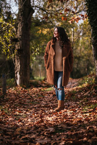 Young woman standing in forest