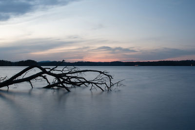 Scenic view of lake against sky during sunset